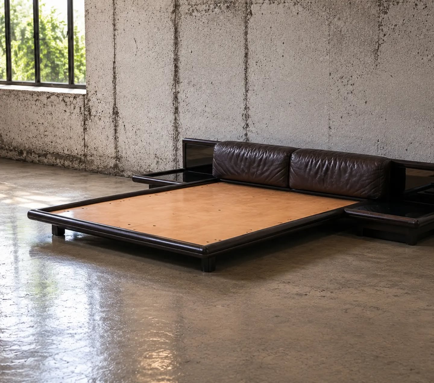 Morna Bed by Afra & Tobia Scarpa for Molteni, Italy, 1972 A masterwork of Italian design from the golden age of modernism, the Morna bed by Afra and Tobia Scarpa for Molteni stands among the most sophisticated bedroom creations of the 1970s. Architectural in conception yet remarkably inviting, it exemplifies the Scarpas' unique ability to unite rigorous geometry with exceptional comfort. Defined by its expansive low-profile frame, integrated bedside platforms and distinctive cylindrical leather cushions, the design blurs the boundary between furniture and architecture. Every element has been carefully considered, creating a harmonious composition that feels both monumental and effortlessly refined. Crafted in richly toned wood with exquisite attention to detail, the Morna reflects the intellectual elegance that made Afra and Tobia Scarpa among the most influential figures in post-war Italian design. Its restrained lines and sculptural presence remain strikingly contemporary more than five decades after its introduction. Highly sought after by collectors and design connoisseurs, the Morna is far more than a bed; it is a landmark piece of twentieth-century Italian design history, perfectly suited to the most discerning interiors. #AfraAndTobiaScarpa #Molteni #MornaBed #ItalianDesign #MidCenturyModern