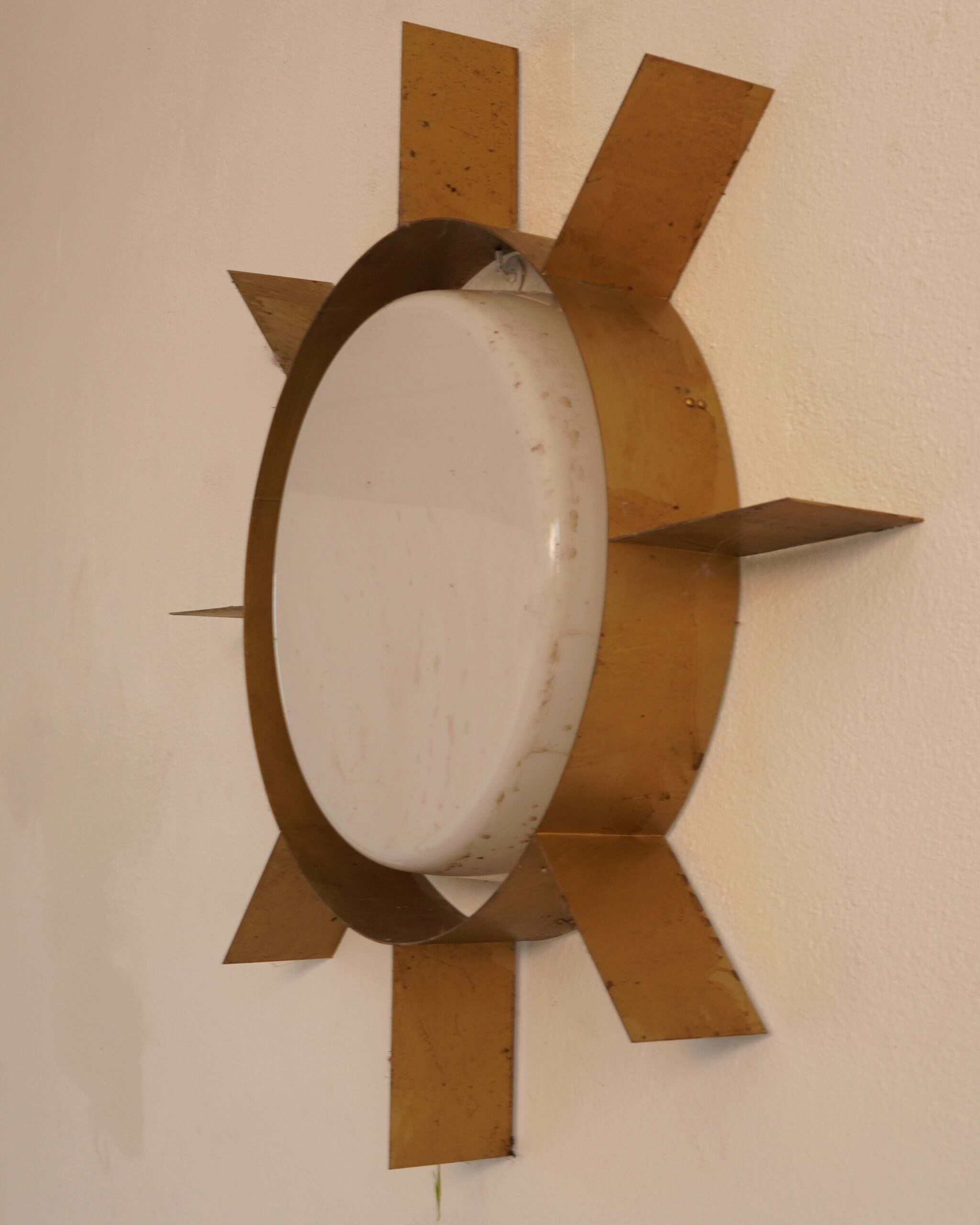 An exceptionally rare and highly sculptural “Sole” wall or ceiling light, designed by Gio Ponti for Arredoluce in 1957. Conceived as an impressionistic representation of the sun, the lamp combines an architectural arrangement of radiating brass elements with a softly rounded central diffuser in white opaline acrylic. The result is wonderfully dramatic, yet unmistakably refined. Preserved in its authentic, untouched condition, with a beautifully matured original patina and its original electrical system. Age-related marks, gentle oxidation and traces of use remain visible, contributing to the piece’s history, character and authenticity. The original wiring should be inspected by a qualified electrician before installation. Dimensions: approximately 73 cm diameter × 10.2 cm depth. A rare and distinguished example of Gio Ponti’s post-war lighting design—witty, architectural and supremely elegant. #GioPonti #Arredoluce #ItalianDesign #MidCenturyLighting #CollectibleDesign