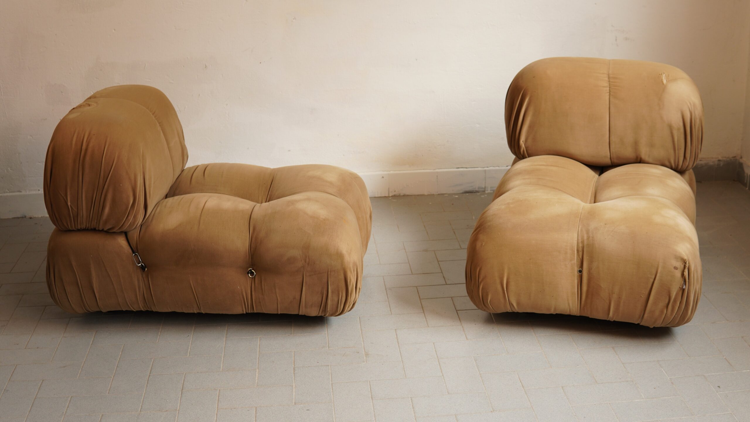 **A Pair of “Camaleonda”, Armchairs by Mario Bellini for B&B Italia** A particularly desirable pair of the compact **Camaleonda armchairs**, designed by Mario Bellini for B&B Italia in 1970. Their voluptuous, unmistakably sculptural forms are upholstered in their original warm beige Alcantara, now displaying a wonderfully time-softened appearance and the honest traces of a long and rather stylish life. Both armchairs retain their **original B&B Italia labels and signatures**. The celebrated system of hooks and cables remains visible, allowing the individual elements to be joined together in Camaleonda’s characteristically informal and endlessly adaptable manner. An authentic early pair, preserved in original vintage condition and possessing precisely the relaxed, cultivated presence for which this icon of Italian design is so admired. #MarioBellini #Camaleonda #BBItalia #ItalianDesign #VintageInteriors